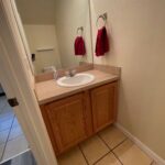 Bathroom vanity with sink and towels.