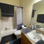 Bathroom with white sink, toilet, and bathtub.