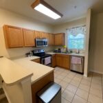 Kitchen with wood cabinets and tile floor.