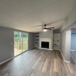 Living room with fireplace and wood floors.