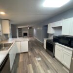 Kitchen with stainless steel appliances and white cabinets.
