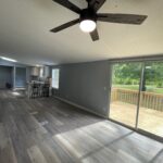 Modern living room with wood floors and deck.