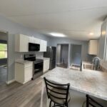 Modern kitchen with island and bar stools.