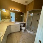 A bathroom with a tiled floor and shower.