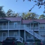 Two-story apartment building with cars parked