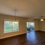 Empty room with hardwood floors and a window.