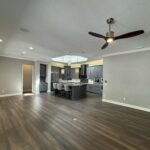 Open floor plan with kitchen island and fireplace.