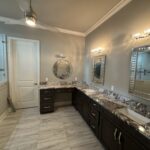 Modern bathroom with granite countertop and shower.