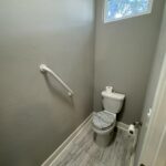 A white toilet with a patterned seat.