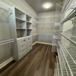 White closet with wire shelves and drawers.