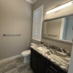 Modern bathroom with white toilet and sink.