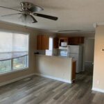 Empty living room with ceiling fan.