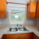 Kitchen sink and countertop with cabinets.