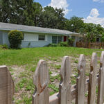 A wooden fence in front of a house.