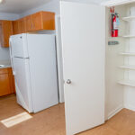 Kitchen with white refrigerator and pantry.