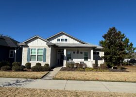 Craftsman-style house, sunny day.