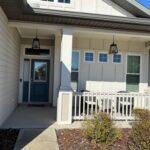 House entrance with porch and lanterns.