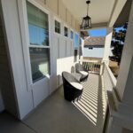 Sunny porch with wicker chairs and light.