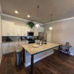 Modern kitchen island with granite countertop.