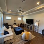 Living room with sectional sofa and TV.