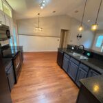 Spacious kitchen with hardwood floors and island.