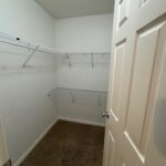 Empty walk-in closet with wire shelves.