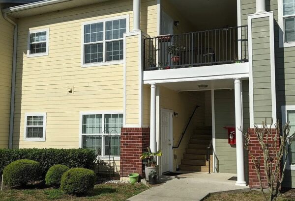 Apartment building entrance with balcony.