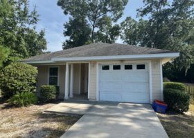 Small house with garage and front yard.